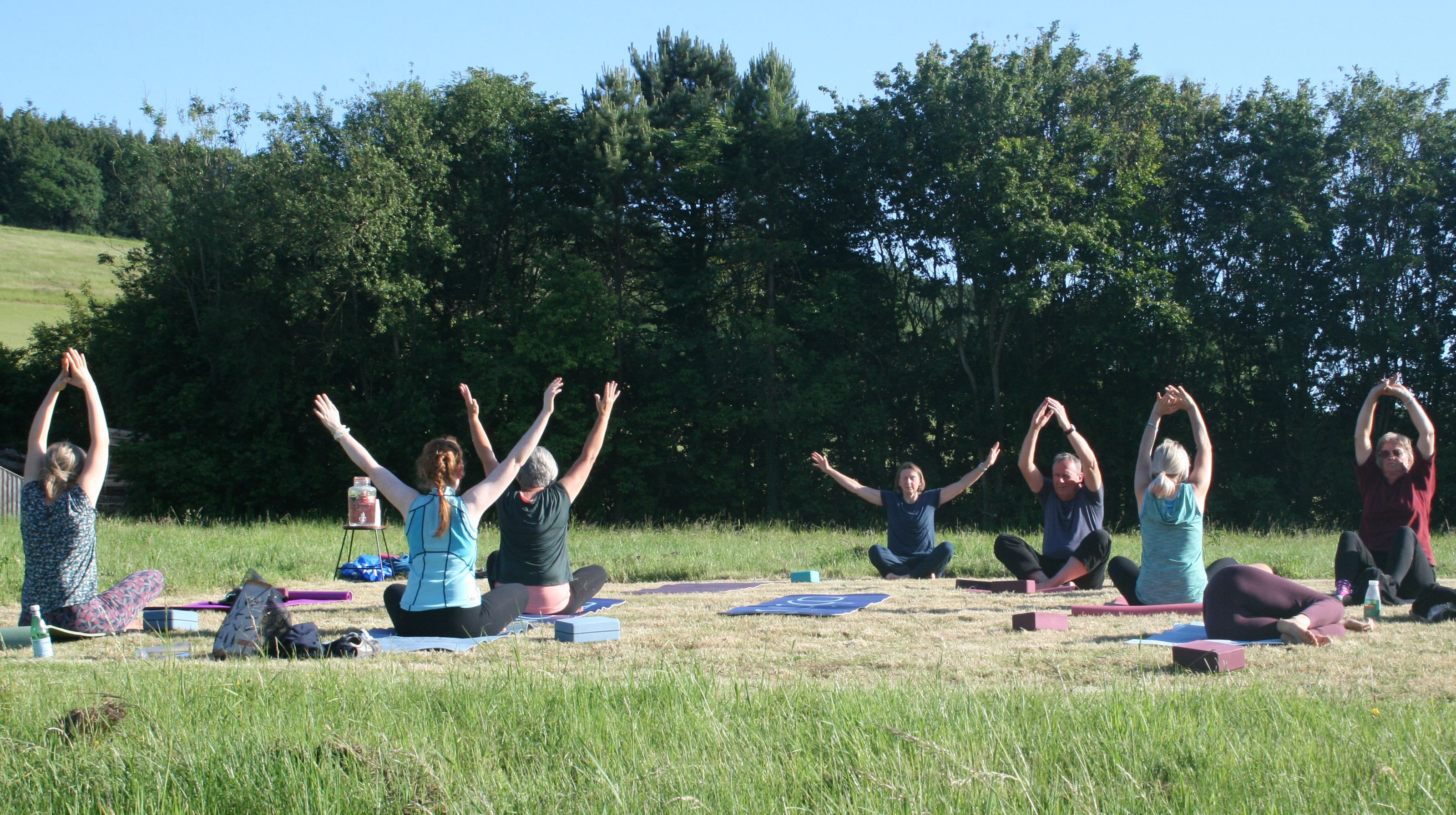 Photo of Charlton residents practicing vinyasa flow yoga
